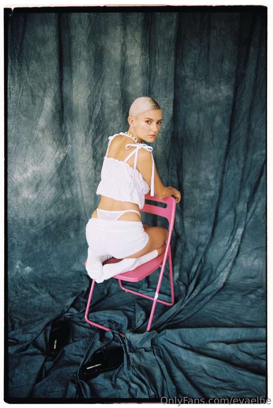 This chair is pink, my outfit is white, and your thoughts ar..